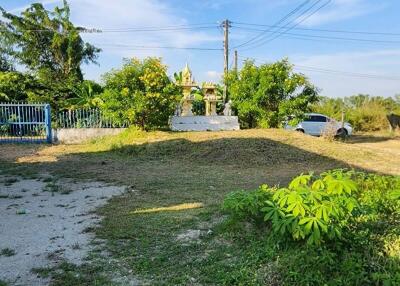 Spacious outdoor area with greenery and clear skies