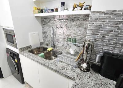 Modern kitchen with stainless steel appliances and granite countertop