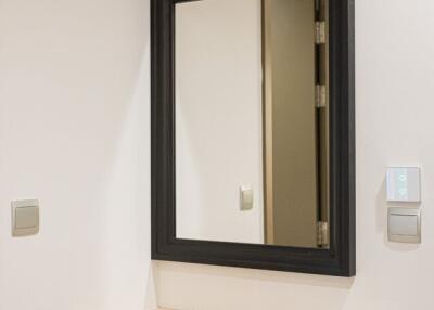 Modern hallway with light wood cabinet and mirror