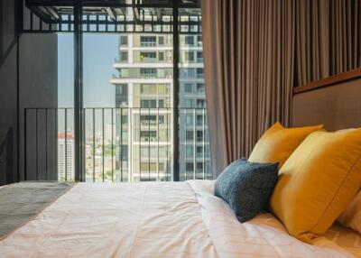 Modern bedroom with a balcony view in an urban apartment