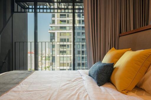 Modern bedroom with a balcony view in an urban apartment