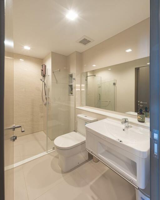 Modern bathroom with glass shower enclosure and large mirror