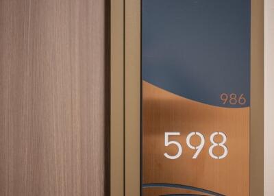 Elegant apartment door number plaque with artistic design