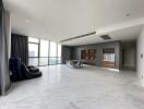 Spacious and modern living room with marble floors and large windows