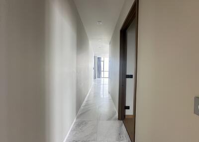 Bright and spacious hallway leading to rooms with marble flooring