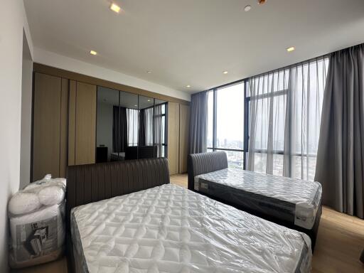 Spacious bedroom with large windows and city view