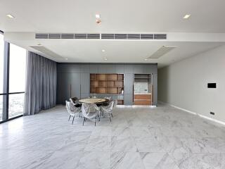 Spacious living room with marble flooring and large windows