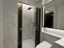 Modern bathroom with marble finish and glass shower