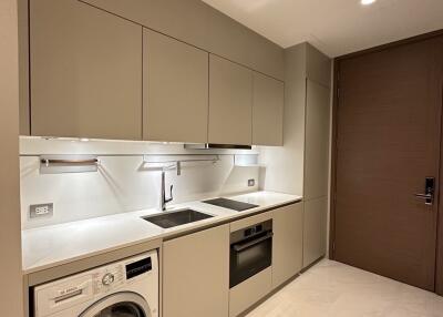 Modern kitchen with built-in appliances and taupe cabinets