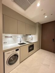 Modern kitchen with built-in appliances and taupe cabinets