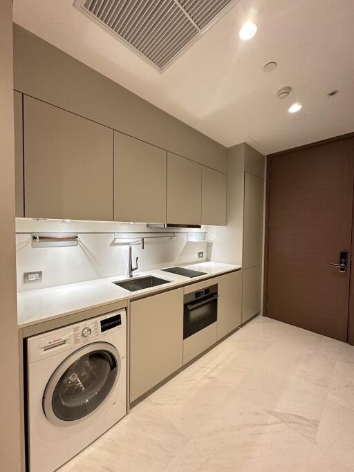 Modern kitchen with built-in appliances and taupe cabinets