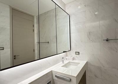 Modern bathroom with marble tiles and large mirror