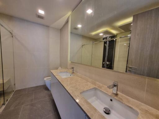 Modern bathroom with double vanity and glass shower