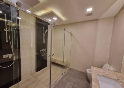 Spacious modern bathroom with glass shower and elegant finishes