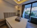 Modern bedroom interior with large bed and window view