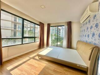 Bright and airy bedroom with large windows and modern design