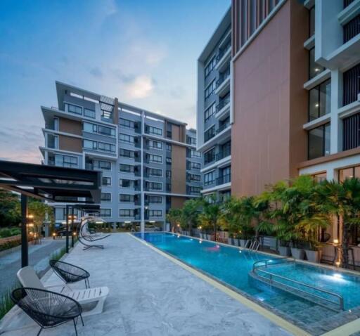 Modern apartment complex with swimming pool at dusk