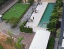 Aerial view of residential building with pool and green space