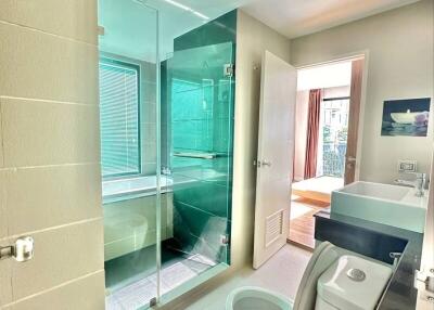 Modern bathroom with glass shower and ample natural light