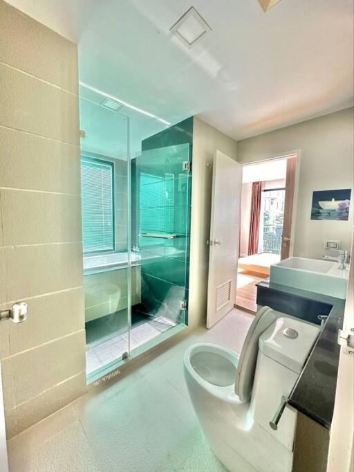 Modern bathroom with glass shower and ample natural light