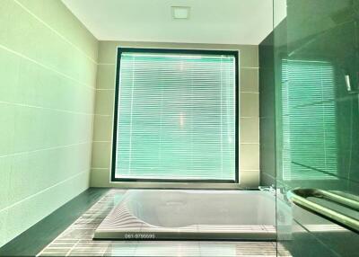 Modern bathroom with natural light filtered through a window blind
