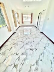 Bright and spacious hallway with marble flooring and natural light
