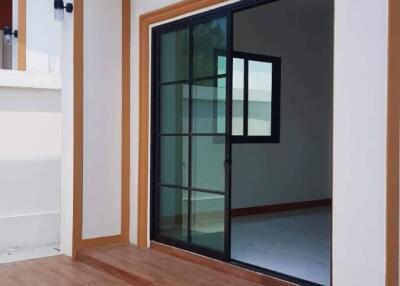 Modern home entrance with wooden flooring and large sliding glass door
