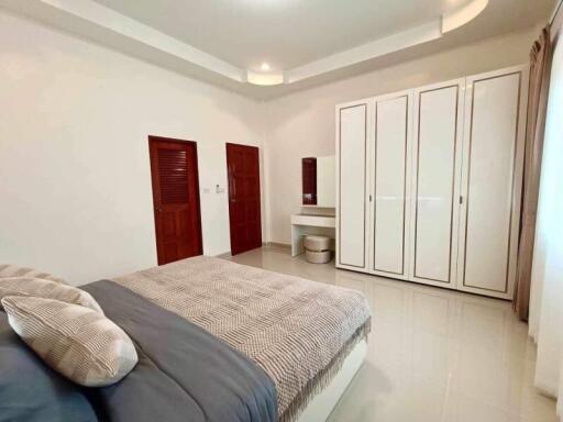 Spacious bedroom with modern decor and ample storage