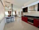 Modern kitchen with red cabinets and stainless steel appliances
