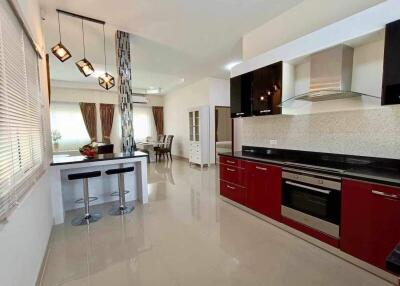 Modern kitchen with red cabinets and stainless steel appliances