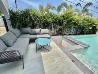 Modern outdoor patio with comfortable seating and private pool