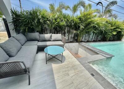 Modern outdoor patio with comfortable seating and private pool