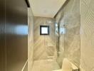Modern bathroom interior with glass shower and elegant tiling