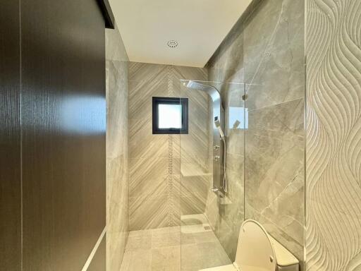 Modern bathroom interior with glass shower and elegant tiling