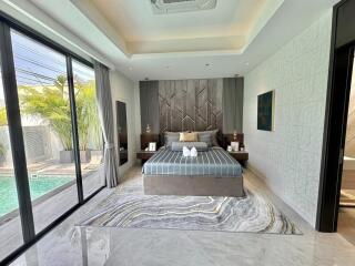 Modern bedroom with pool view and luxurious interior design