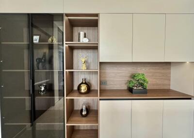 Modern living room wall with built-in shelving and decorative items