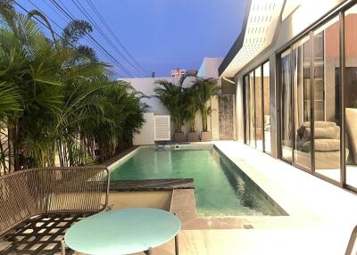 Modern home outdoor area with swimming pool and seating