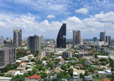 Cityscape view showcasing various buildings under a blue sky with clouds