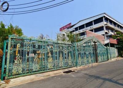 Exterior view of a multi-story building with decorative metal gate