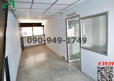 Spacious unfurnished commercial building interior with large windows and tiled flooring