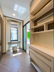 Bright walk-in closet with built-in shelving and a center island