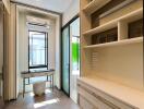 Bright walk-in closet with built-in shelving and a center island