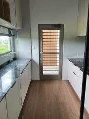 Modern kitchen interior with wooden floor and granite countertops