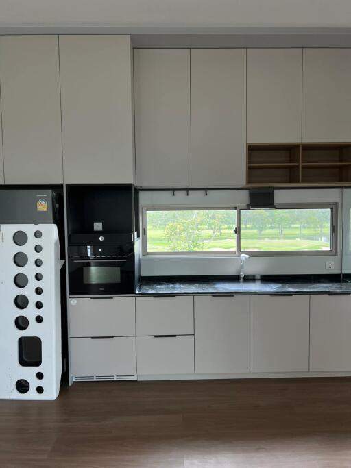 Modern kitchen with built-in appliances and a view of the outdoors