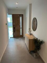 Modern hallway interior with wooden front door and minimalist decor