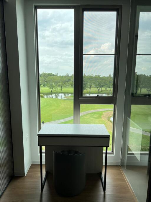 Bright office space with a view of greenery through tall windows