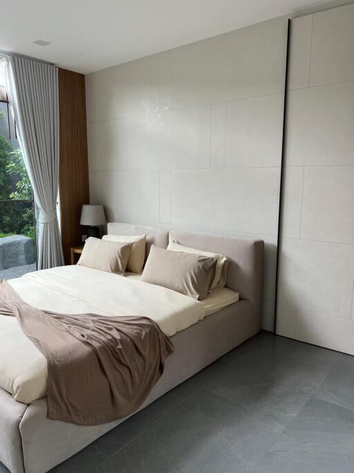 Modern bedroom with a king-size bed and minimalist decor