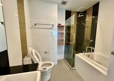 Modern bathroom with white fixtures and mosaic tile details