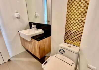 Modern bathroom with golden mosaic tiles