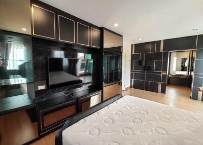 Spacious bedroom with large bed and built-in cabinetry